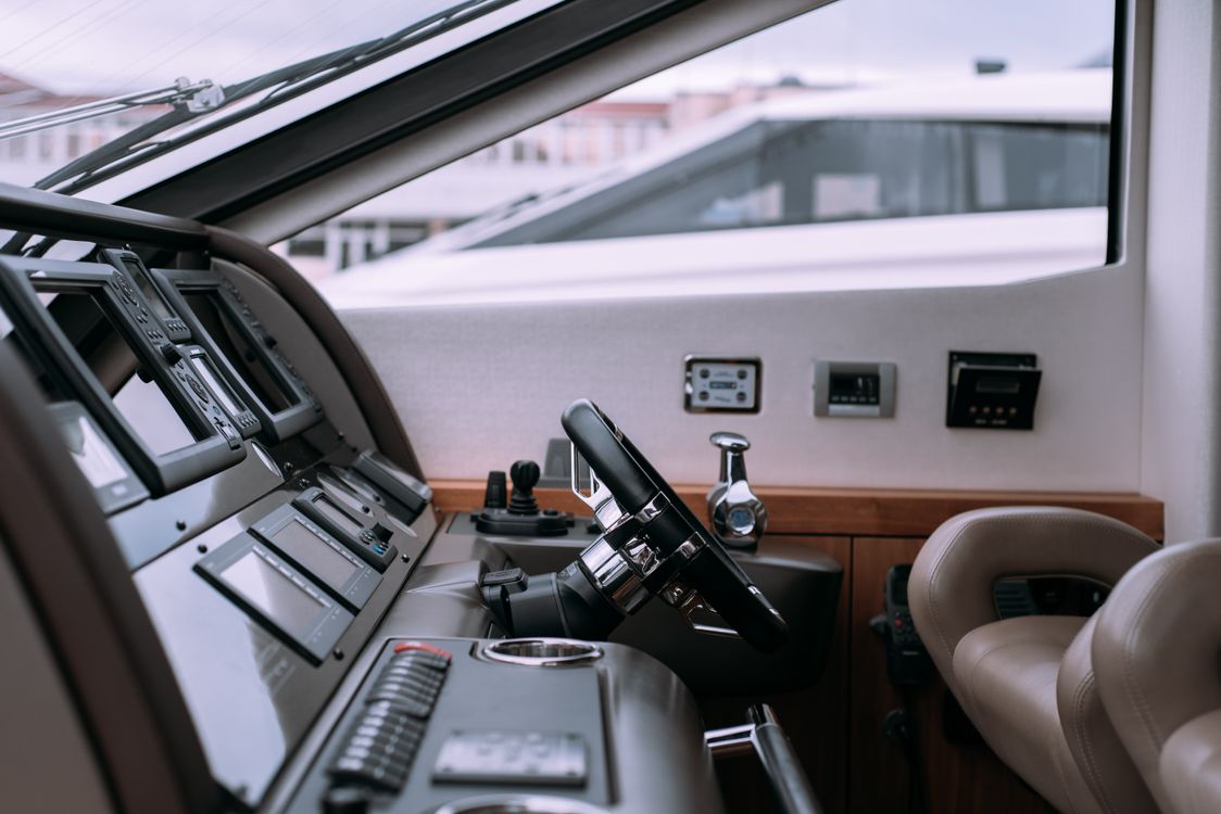 Modern yacht helm with navigation displays and marine controls